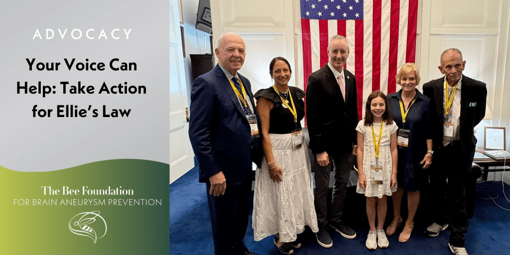 Six people, including a child, stand smiling in front of an American flag at an advocacy event for Ellies Law, organized by The Bee Foundation for Brain Aneurysm Prevention. A sign encourages taking action for the cause.