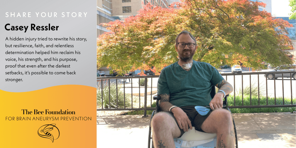 A man with glasses and facial hair sits in a wheelchair outdoors, with trees and buildings in the background. Text beside him shares his story of resilience after a brain aneurysm. Logo: The Bee Foundation for Brain Aneurysm Prevention.