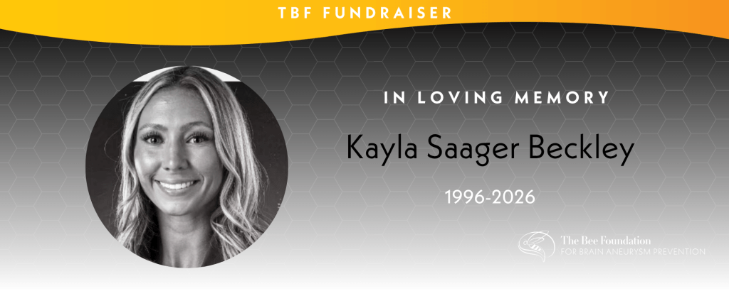 Black and white photo of a smiling woman with long hair. Text reads: TBF Fundraiser, In Loving Memory, Kayla Saager Beckley, 1996-2026. The Bee Foundation logo appears in the bottom right.